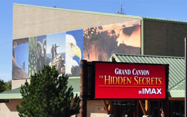 A billboard outside an IMAX theater advertises a Grand Canyon film.